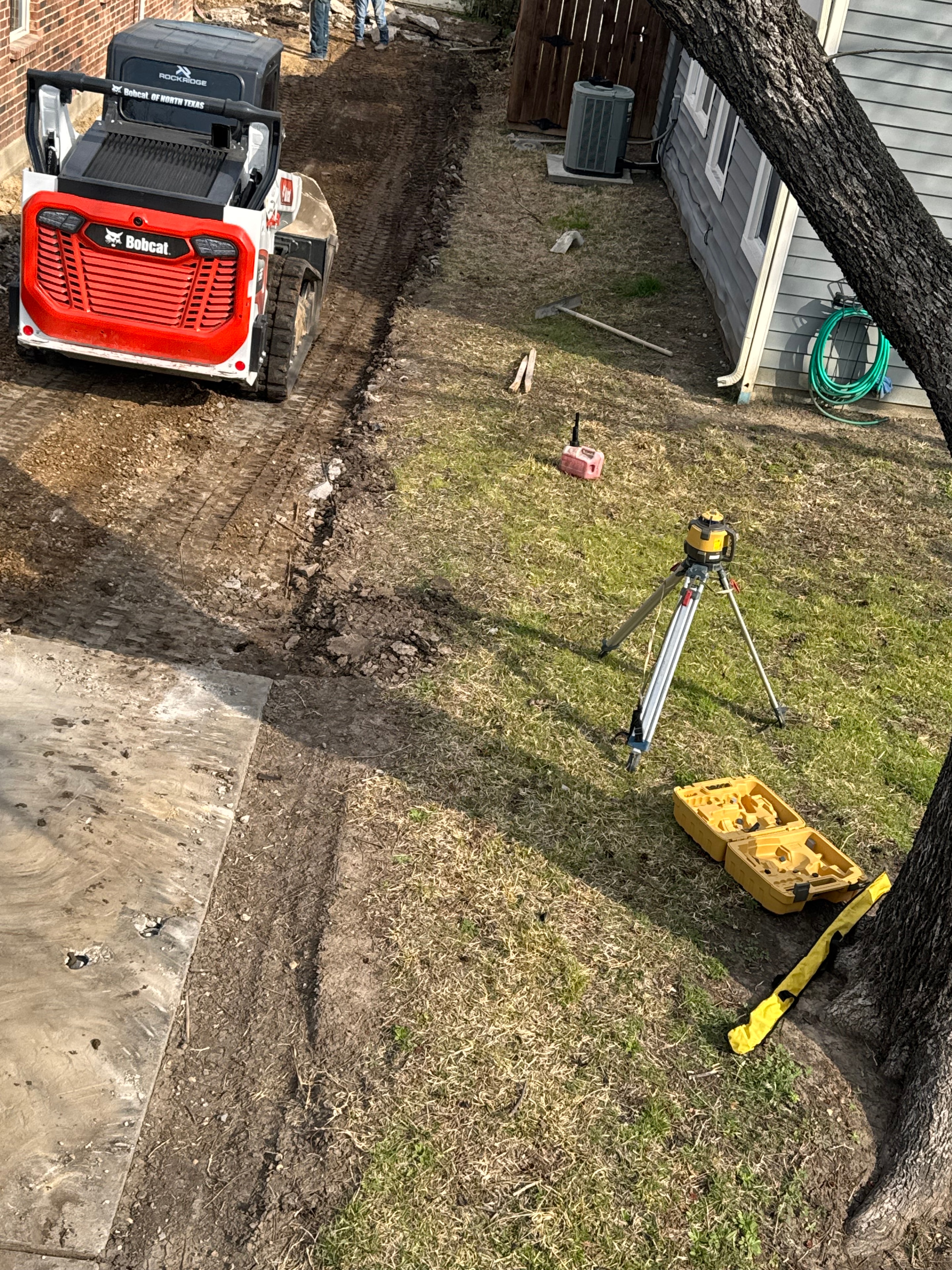 Bobcat skid steer with laser level on a grading job site